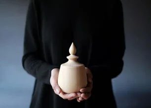 骨壺を持つ手